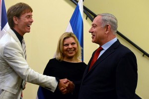 Prime Minister Benjamin Netanyahu shakes hands with British pop singer Sir Cliff Richard in Jerusalem, while Israeli PM's wife Sara looks on. (Kobi Gideon/Flash90)