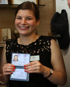 Becky Kupchan, 26, proudly shows her Israeli citizenship card upon making aliyah from Chicago to Be'er Sheva on Tuesday. (Photo: Sasson Tiram, courtesy Nefesh B'Nefesh)