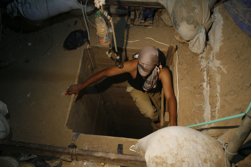 A terrorist emerges from a tunnel. (Khaled Omar/propaimages)