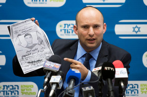 Ministro de Economía, Naftali Bennett, en una reunión reciente de la Knesset, sostiene una foto de Adbel-Rahman Shaloudi, que conducía su coche en una estación de tren y mató a una mujer y un bebé. (Foto: Yonatan Sindel / Flash90)