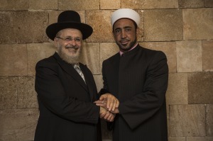 The Chief Rabbi of Akko, Yosef Yashar (L), and the main Imam of Akko, Sheikh Samir Assi (R ), shake hands (Photo: Hadas Parush/Flash90)