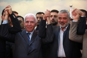 Head of the Hamas government Haniyeh (R) and Senior Fatah official  Al-Ahmed (L) announce a reconciliation agreement in Gaza City April 23, 2014.  (Photo: Arabs protests in Gaza over dire situation. (Photo: Rahim Khatib/Flash90)