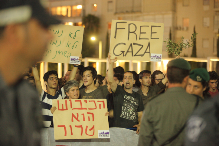 Israeli left wing activists holding placards during a demonstration. (Photo by Yossi Aloni/Flash90)