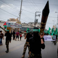 Masked terrorists march in a rally