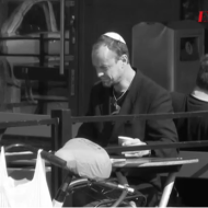 Petter Ljunggren sits in a cafe wearing a 'kippa' shortly before he was violently confronted by anti-Semites. (Screenshot)