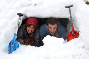 Jerusalemites pose for a photo inside an igloo they built in the snow in Sacher Park, after a major snow storm. (Photo: Nati Shohat/Flash 90)