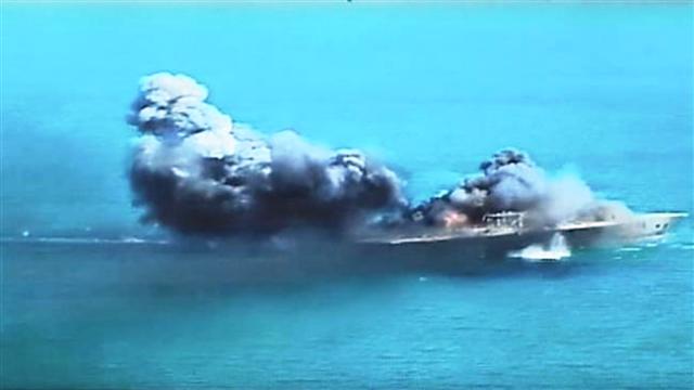 A replica of a US ship explodes during Iranian naval maneuvers.