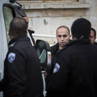 Rami Alami (2L) An Arab attorney from east Jerusalem seen surrounded by guards after a court hearing in the Magistrate's Court in Jerusalem on March 12, 2015. (Yonatan Sindel/Flash90)