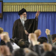 Supreme Leader Ayatollah Ali Khamenei waves while attending a meeting with a group of environmental officials and activists at his residence in Tehran, Iran, Sunday, March, 2015. (AP/Office of the Iranian Supreme Leader)