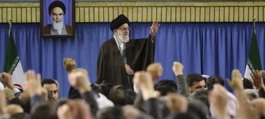 Supreme Leader Ayatollah Ali Khamenei waves while attending a meeting with a group of environmental officials and activists at his residence in Tehran, Iran, Sunday, March, 2015. (AP/Office of the Iranian Supreme Leader)