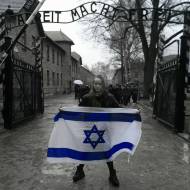 Miriam Ciss Outside Auschwitz Concentration Camp with Flag of Israel