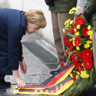 German Chancellor Angela Merkel lays a wreath at Dachau