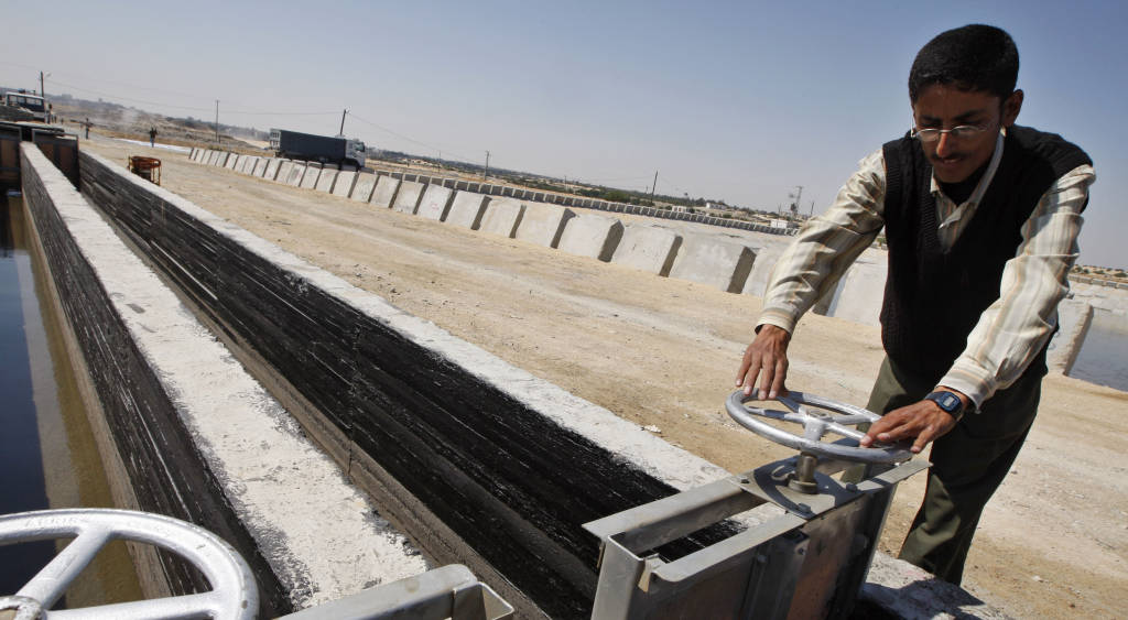 A Palestnian checks water pipes