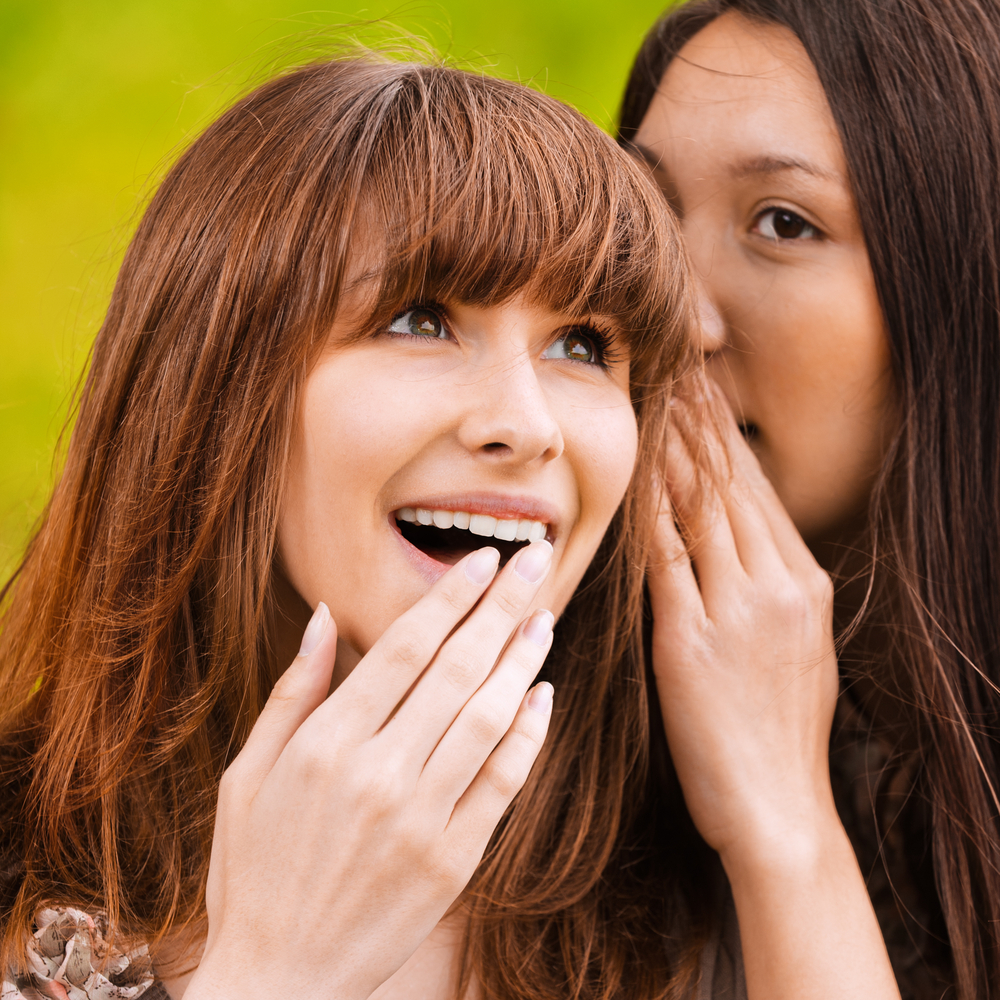 Girls whispering