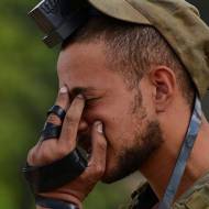 Israeli soldier praying wearing tefillin