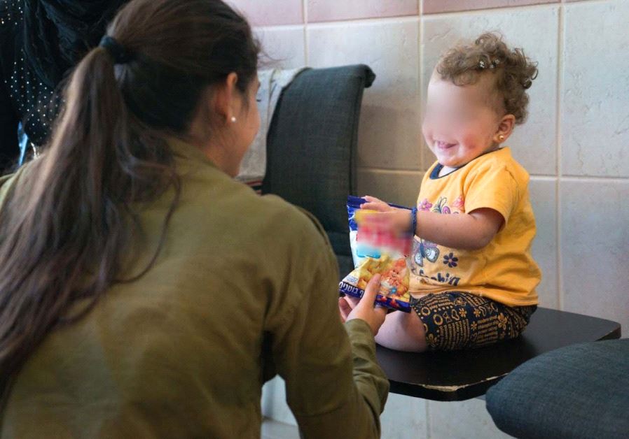 IDF soldier and Syrian child (IDF)