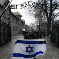 Holding Israeli flag at Auschwitz