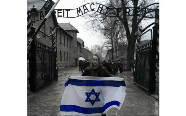 Holding Israeli flag at Auschwitz