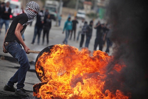 Palestinians burn tires in protest against Israel