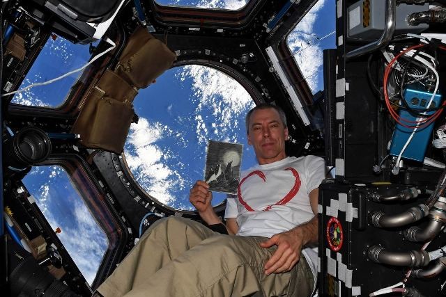 US Astronaut Andrew Feustel and a copy of Petr Ginz's "Moon Landscape" in Space