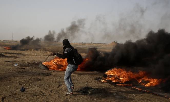 Palestinian rioter on the Gaza fence
