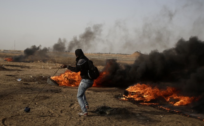Palestinian rioter on the Gaza fence