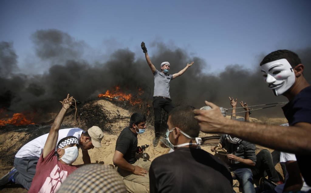 Palestinians setting fires during violent riots in the Gaza Strip. (AP Photo/Adel Hana)
