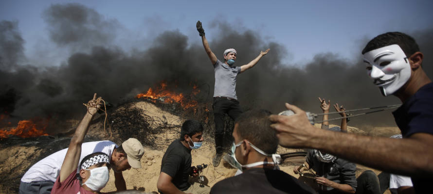 Palestinians setting fires during violent riots in the Gaza Strip. (AP Photo/Adel Hana)