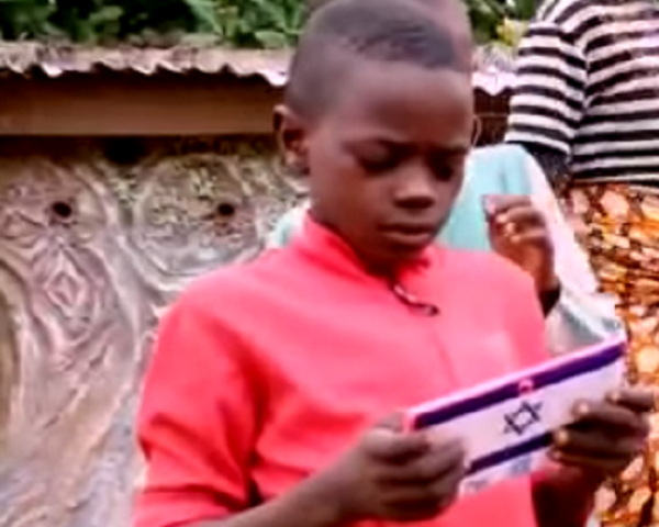 A Nigerian boy uses the tablet he was given through an Israeli program