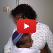 Miri Tamano with one of her children. (screenshot)