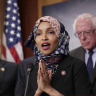 Freshman Rep. Ilhan Omar, D-Minn., center, joins Rep. Peter Welch, D-Vt., left, and Sen. Bernie Sanders, I-Vt. (AP Photo/J. Scott Applewhite)