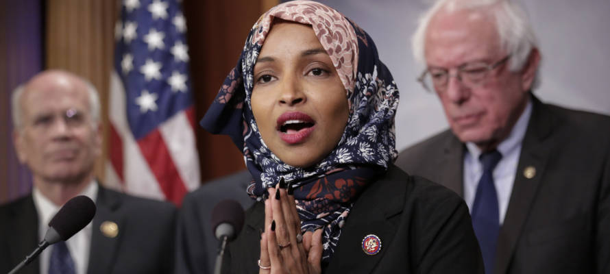 Freshman Rep. Ilhan Omar, D-Minn., center, joins Rep. Peter Welch, D-Vt., left, and Sen. Bernie Sanders, I-Vt. (AP Photo/J. Scott Applewhite)
