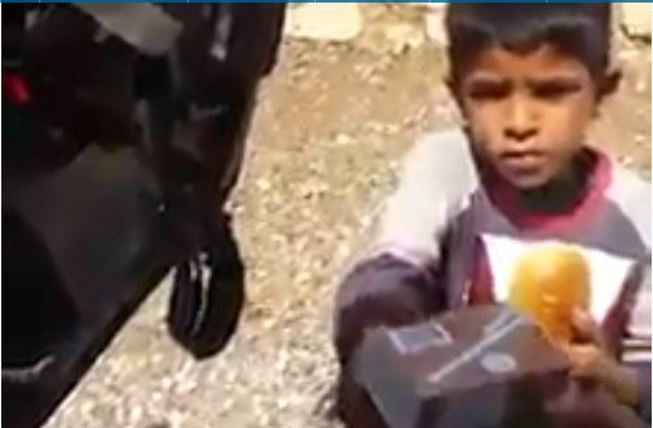 Palestinian child gets lunch from IDF soldier