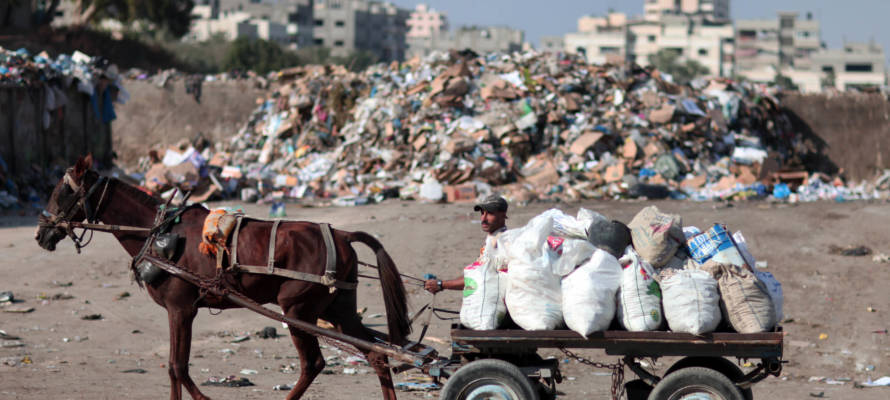 A Palestinian at a dump in Gaza City. (Wissam Nassar/Flash90)