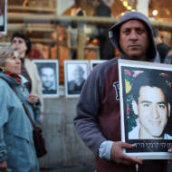 Israeli protesters display photos of victims of Palestinian terror.