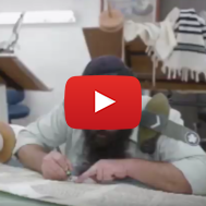 An Army rabbi writes a Torah scroll. (screenshot)