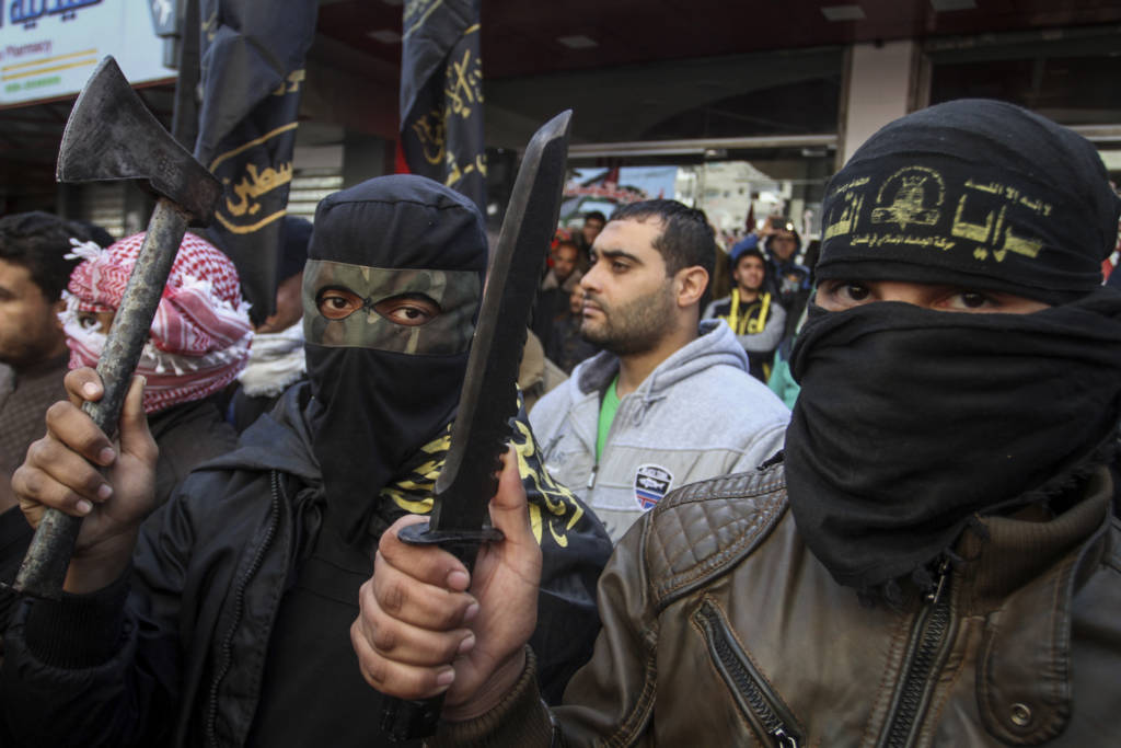 Palestinians glorify terror in an anti-Israel rally. (Abed Rahim Khatib/Flash90)