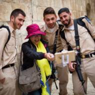 A tourist seen taking selfies with soldiers in Jerusalem's Old City. (Corinna Kern/FLASH90)