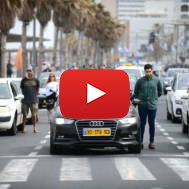 People stand still in Tel Aviv, as a two-minute siren is sounded. (Tomer Neuberg/Flash90)