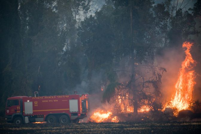 Fire fighters try to extinguish a forest fire near Kibbutz Harel, on May 23, 2019. (Yonatan Sindel/Flash90)
