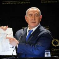 Israeli PM Benjamin Netanyahu with a map from President Donald Trump. (Noam Revkin Fenton/Flash90)