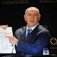 Israeli PM Benjamin Netanyahu with a map from President Donald Trump. (Noam Revkin Fenton/Flash90)
