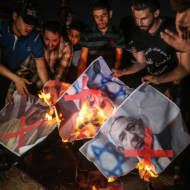 Palestinians in Gaza burn pictures