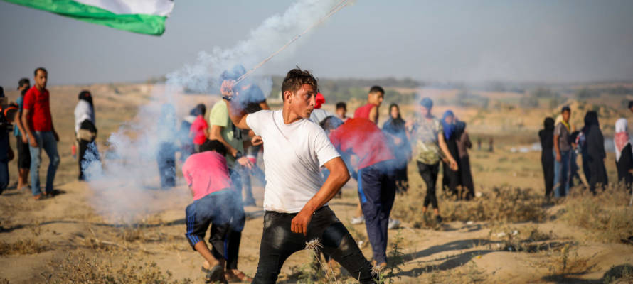 Palestinian protesters clash with Israeli forces at the Israel-Gaza border, July 26, 2019.
