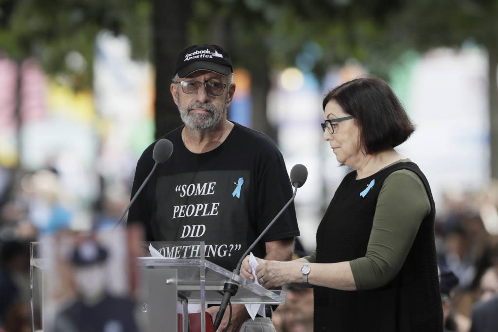 Nic Haros, left, participates in the ceremony marking the 18th anniversary of the attacks of Sept. 11, 2001 at the National September 11 Memorial, Wednesday, Sept. 11, 2019 in New York