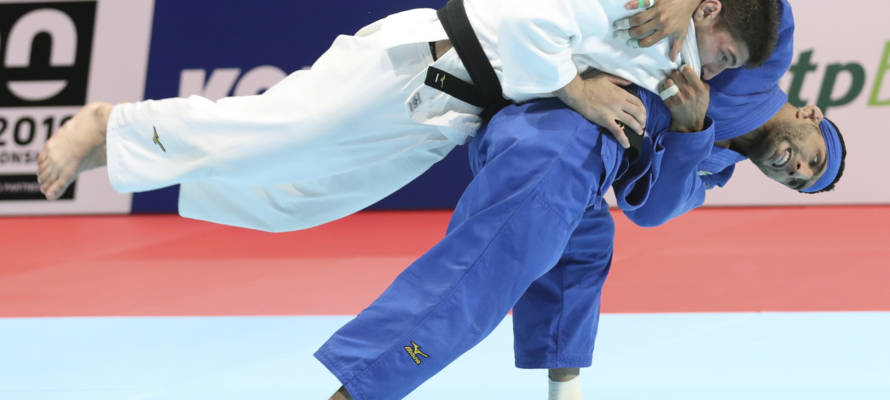 Luka Maisuradze of Georgia, top, competes against Saeid Mollaei of Iran during a men's -81 kilogram bronze medal match of the World Judo Championships in Tokyo, Wednesday, Aug. 28, 2019.