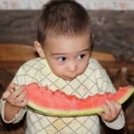 little boy eating watermelon