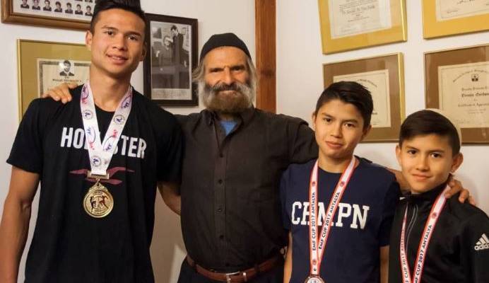 Brothers Kibedy, Ruach Hashem and Ahavat Hashem Gordon with their father, Azriel. (Courtesy)