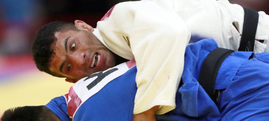 In this Thursday, Aug. 30, 2018 file photo, Saeid Mollaei of Iran, top, competes against Didar Khamza of Kazakhstan during their men's - 81kg final judo match at the18th Asian Games in Jakarta, Indonesia.