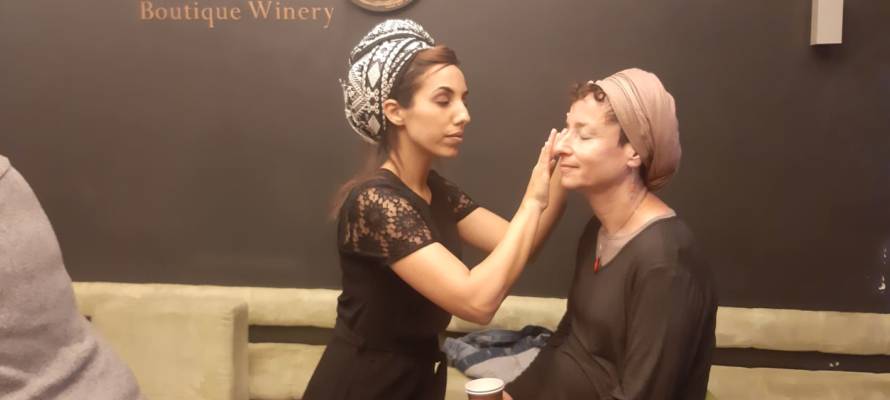 Volunteer puts make-up on B'Shvilech participant (Courtesy)
